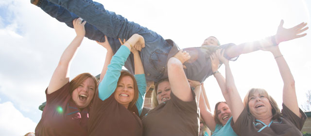 Staff holding up another staff member